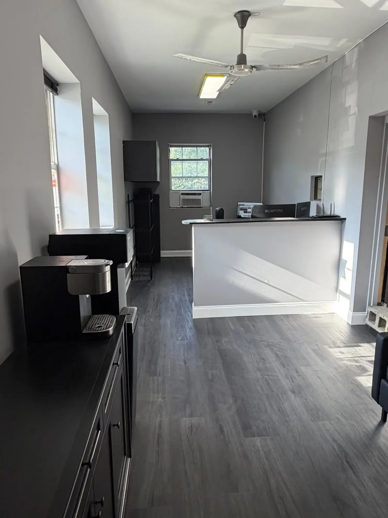 Renovated front office with grey plank flooring and refinished reception counter