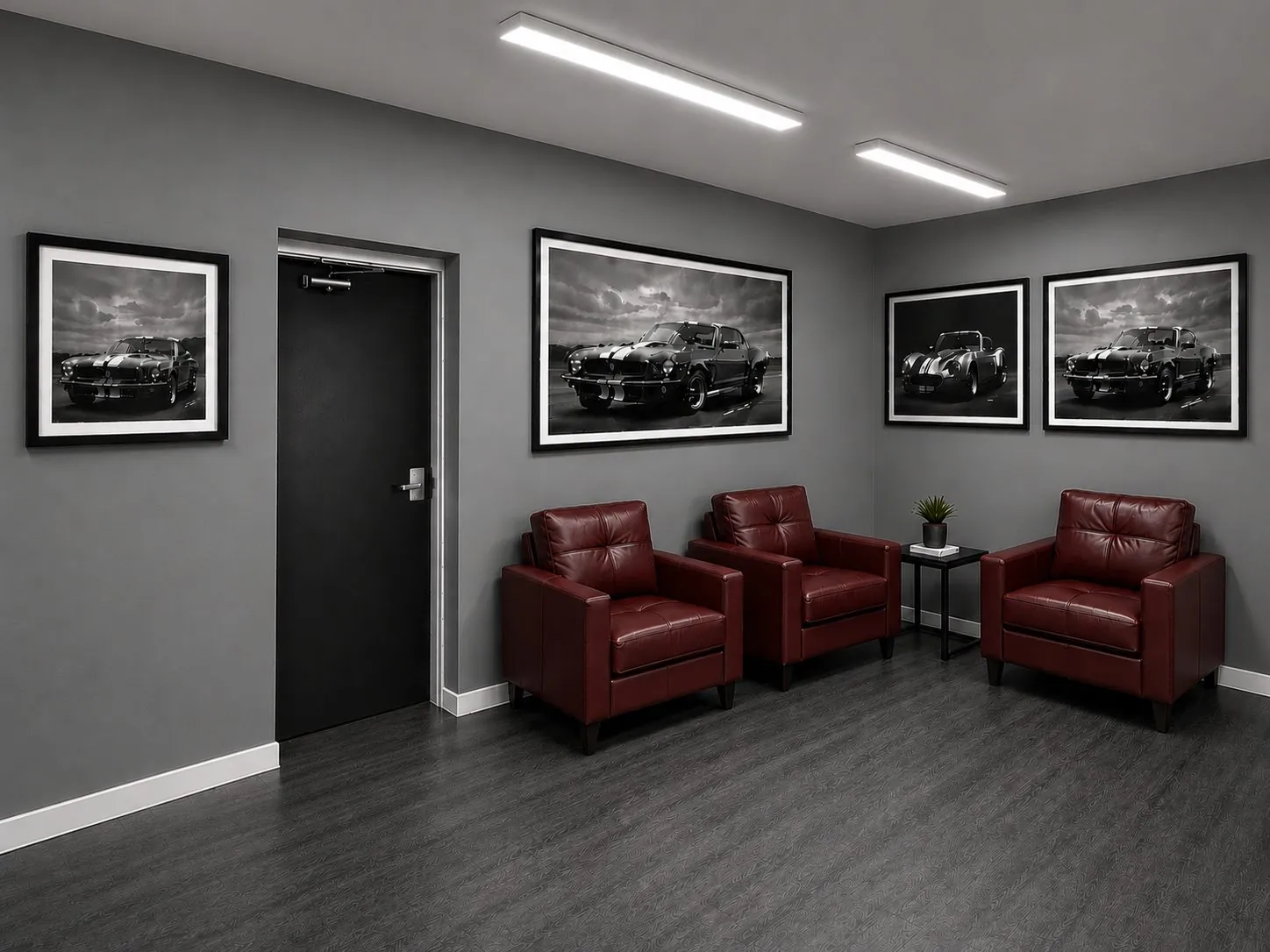 Design rendering of a waiting area with leather chairs and framed car prints