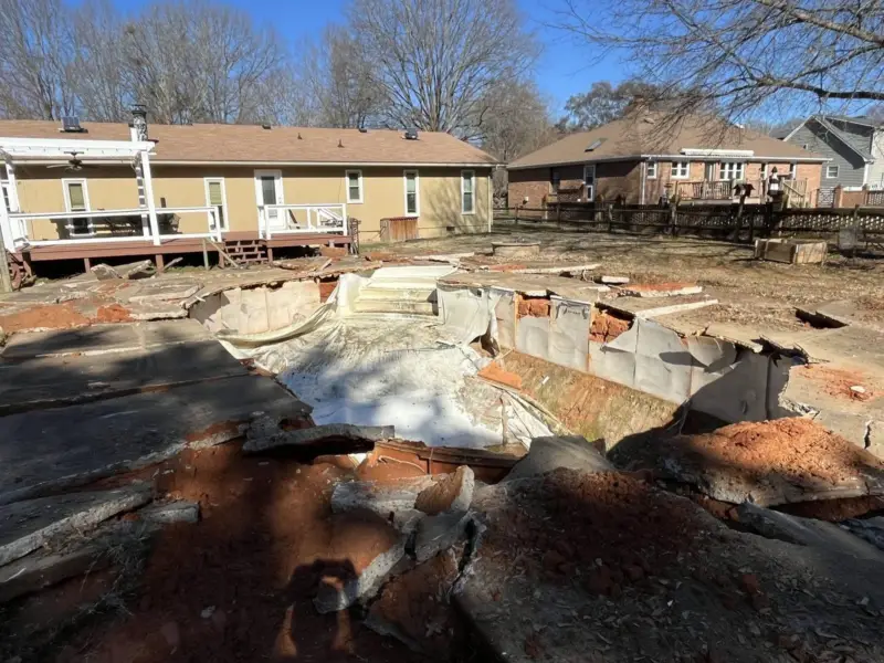 Old in-ground pool broken out before the fill-in, an Apex job
