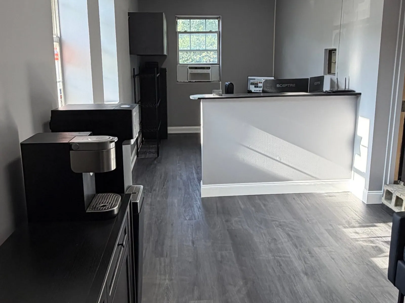 The same front office after renovation with plank flooring and a refinished counter
