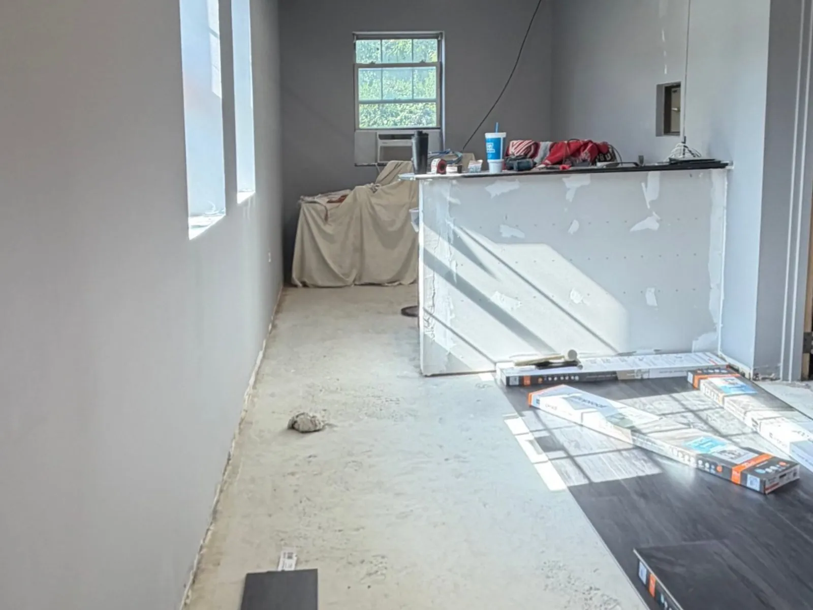 Front office during renovation with bare concrete floor