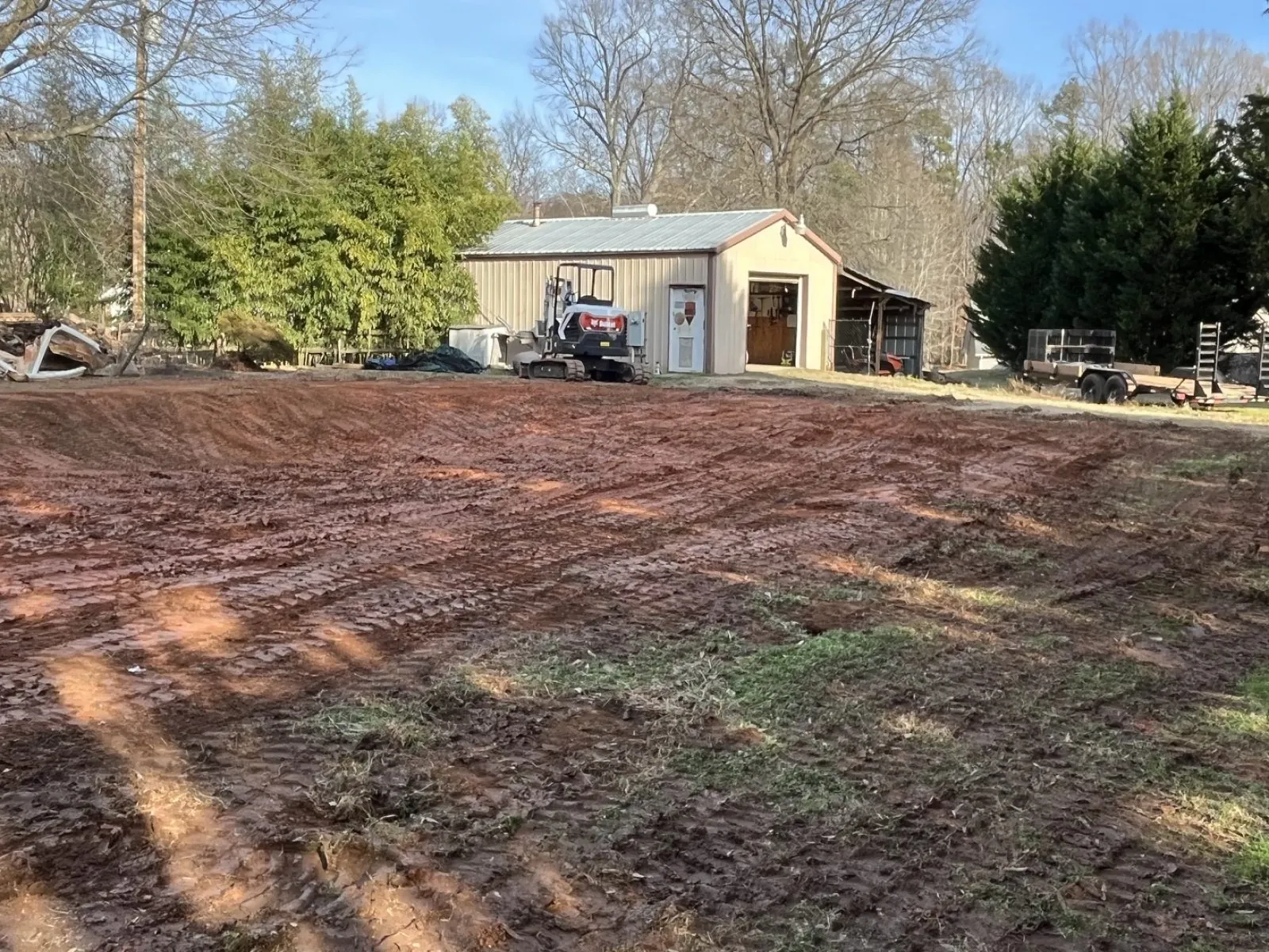 Pool area backfilled and graded with the Apex Bobcat E40